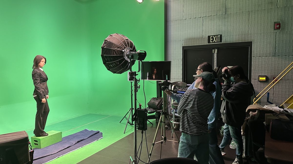 Media Arts students at work in the production studio with green screen, lighting, and cameras